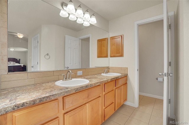 full bathroom with double vanity, tile patterned flooring, ceiling fan, and a sink