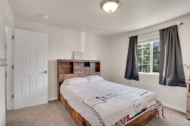 carpeted bedroom with baseboards