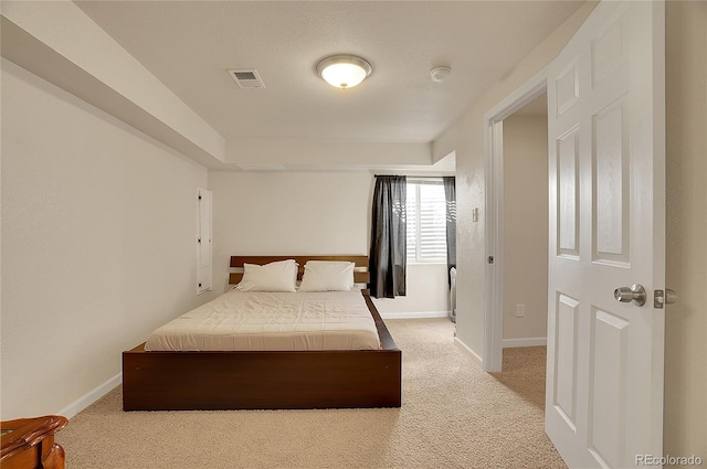 bedroom featuring light colored carpet, visible vents, and baseboards