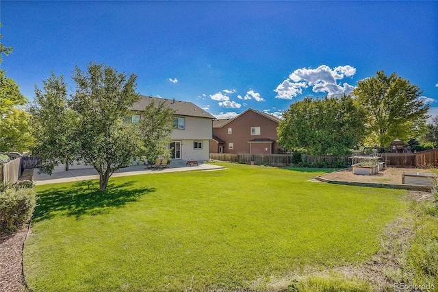 view of yard with a patio area, a vegetable garden, and fence