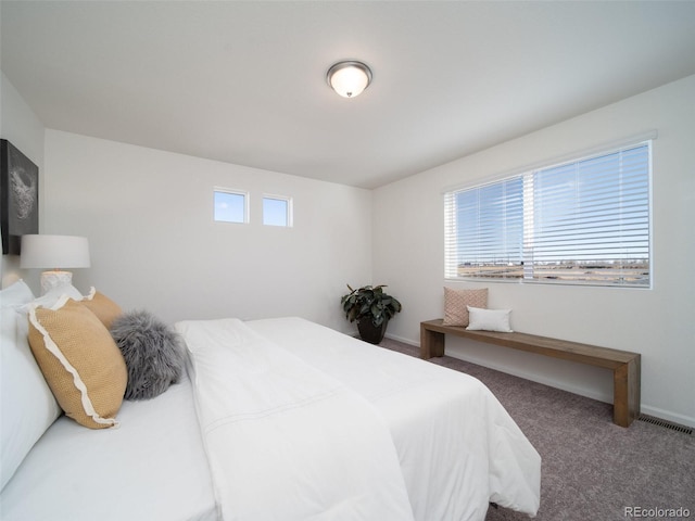 bedroom with dark colored carpet