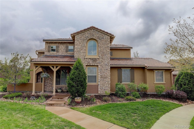 9592 Firenze Way, Highlands Ranch, CO 80126 - mediterranean / spanish house featuring a tiled roof, a front yard, and covered porch