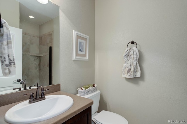9592 Firenze Way, Highlands Ranch, CO 80126 - bathroom featuring vanity, toilet, and a tile shower