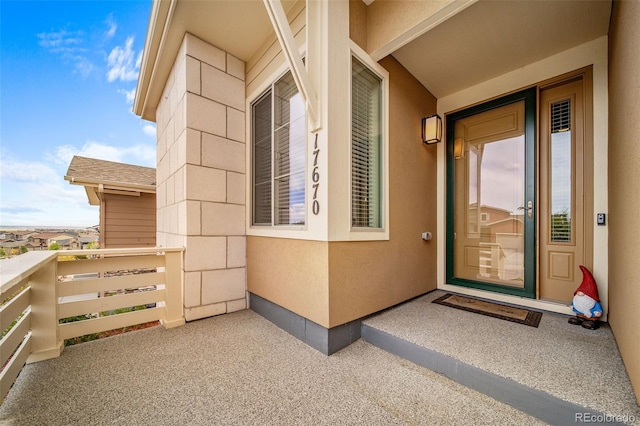 17670 W 94th Dr, Arvada, CO 80007 - doorway to property featuring stucco siding and a balcony