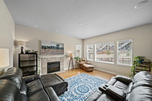 17670 W 94th Dr, Arvada, CO 80007 - living room featuring baseboards, a fireplace, and wood finished floors
