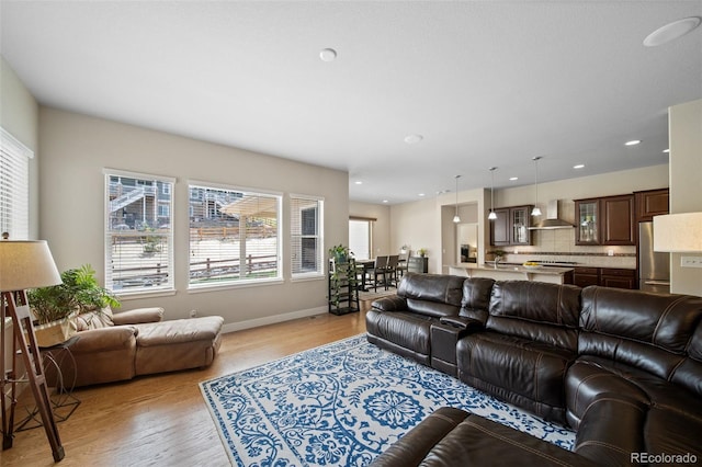 17670 W 94th Dr, Arvada, CO 80007 - living room with baseboards, recessed lighting, and light wood-style flooring