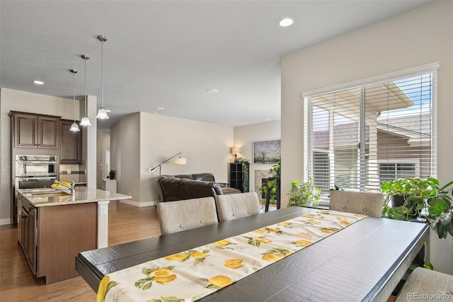 17670 W 94th Dr, Arvada, CO 80007 - dining room featuring baseboards, recessed lighting, and light wood-style flooring