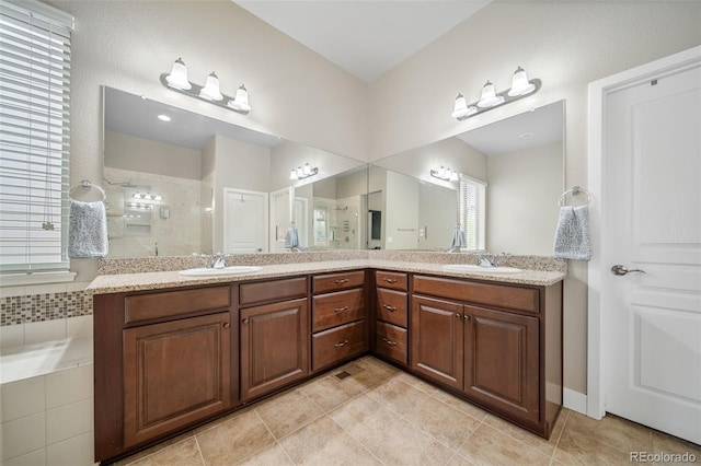 17670 W 94th Dr, Arvada, CO 80007 - bathroom featuring a sink, tile patterned flooring, double vanity, and tiled shower
