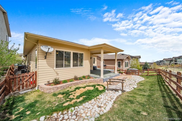 17670 W 94th Dr, Arvada, CO 80007 - back of property with a lawn, a patio, and a fenced backyard