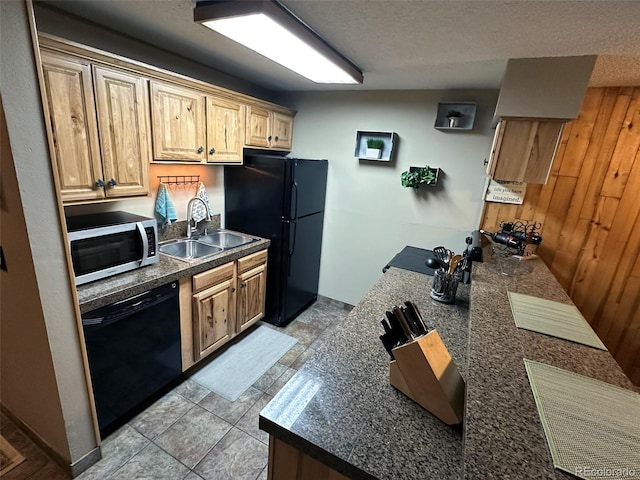 kitchen with wood walls, sink, a textured ceiling, and black appliances