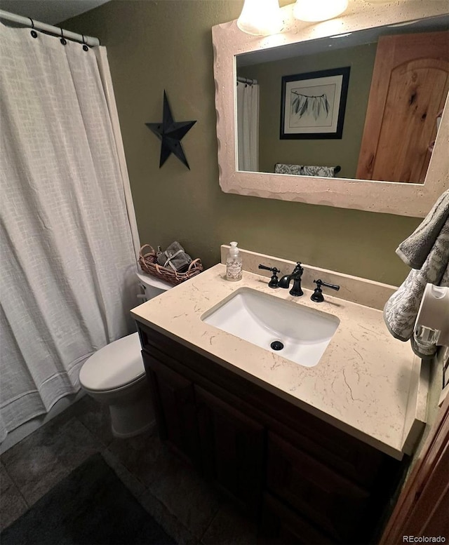 bathroom with vanity, toilet, and tile patterned flooring