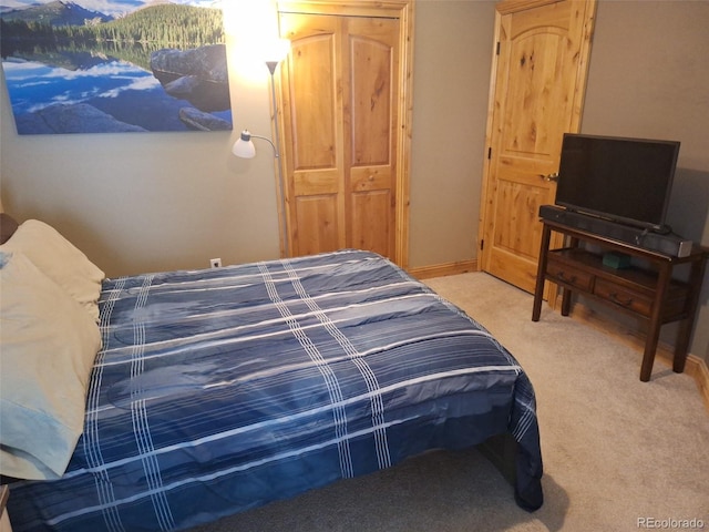 bedroom with light colored carpet and a closet