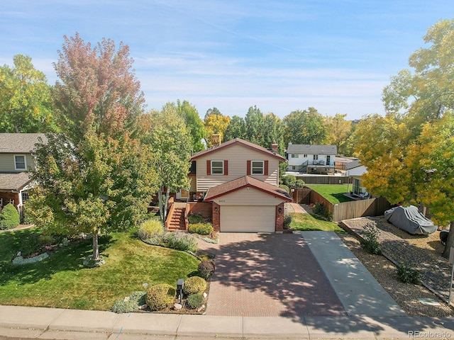 front facade with a garage and a front lawn