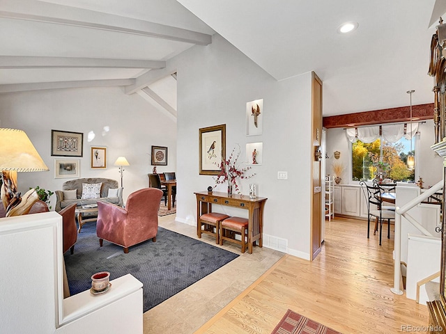 living room with lofted ceiling with beams and light wood-type flooring