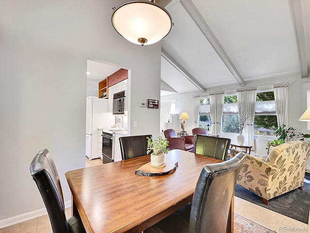 dining space featuring light tile patterned floors and vaulted ceiling with beams