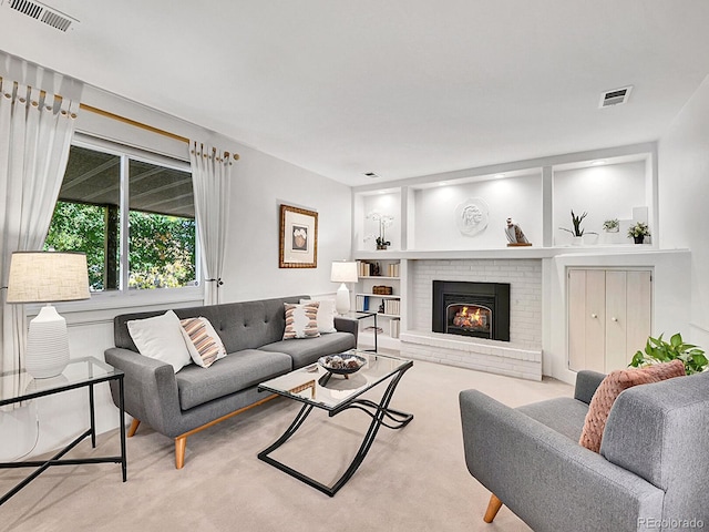 carpeted living room featuring a brick fireplace