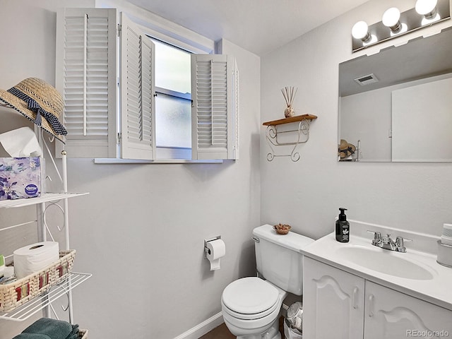 bathroom with toilet and vanity