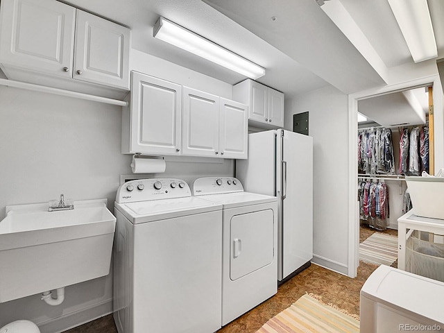 laundry area with sink, independent washer and dryer, and cabinets