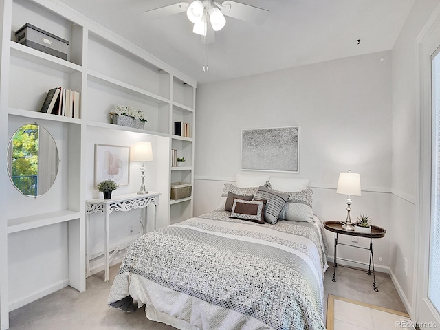 carpeted bedroom with ceiling fan and multiple windows