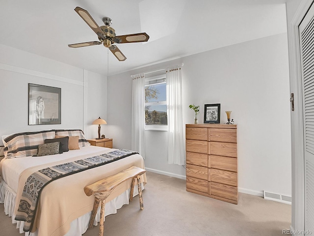 carpeted bedroom featuring a closet and ceiling fan