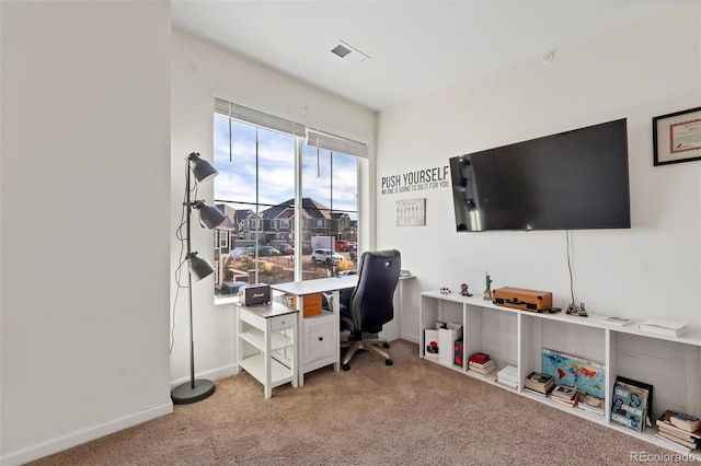 office area featuring light carpet