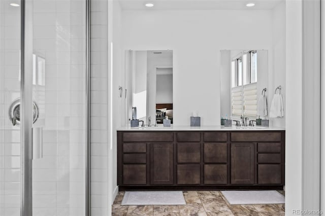 15606 W Girard Ave, Morrison, CO 80465 - bathroom featuring double vanity, a sink, recessed lighting, and a shower stall