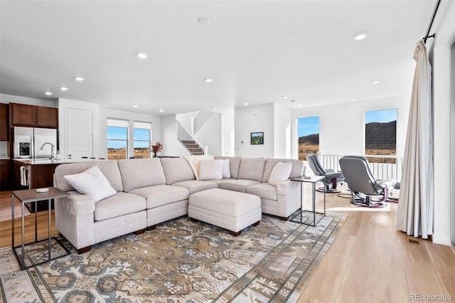 15606 W Girard Ave, Morrison, CO 80465 - living room featuring recessed lighting, stairway, and light wood-type flooring