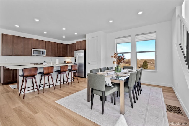 15606 W Girard Ave, Morrison, CO 80465 - dining area featuring recessed lighting, baseboards, light wood-style floors, and visible vents