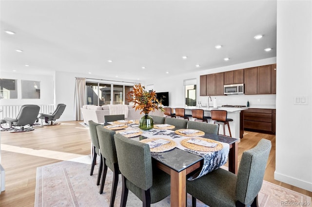 15606 W Girard Ave, Morrison, CO 80465 - dining space with baseboards, light wood-style floors, and recessed lighting