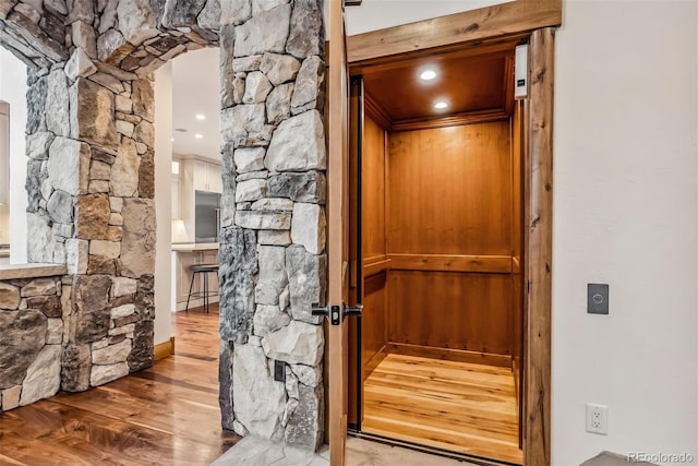 interior space with hardwood / wood-style flooring and elevator