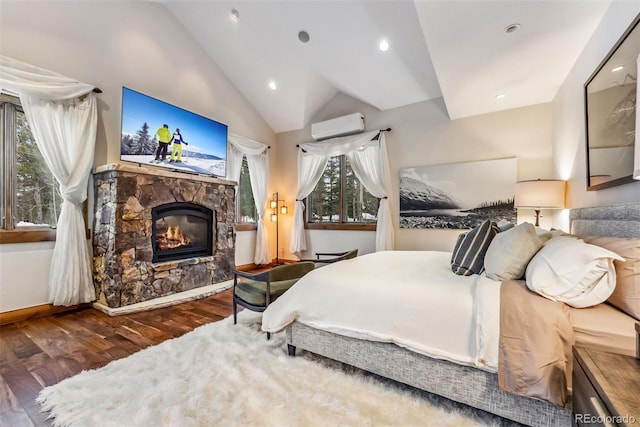 bedroom featuring an AC wall unit, dark wood-type flooring, lofted ceiling, and a fireplace