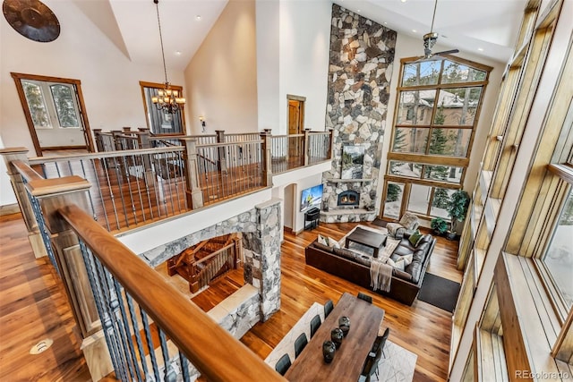 interior space with light hardwood / wood-style floors, high vaulted ceiling, and an inviting chandelier