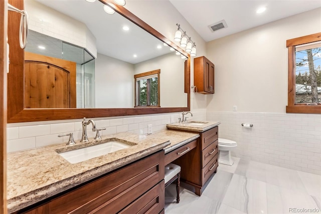 bathroom featuring tile walls, toilet, and vanity