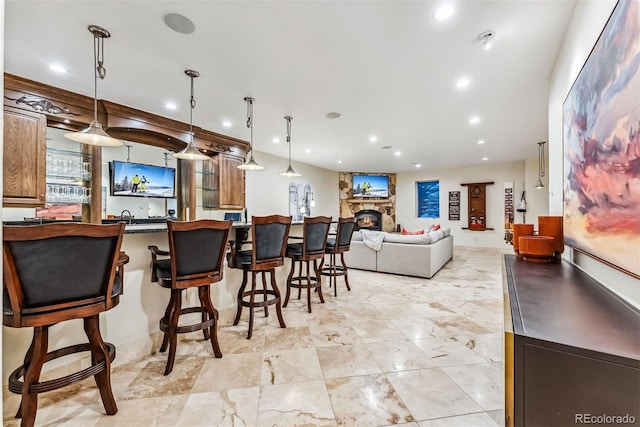 bar featuring pendant lighting and a fireplace