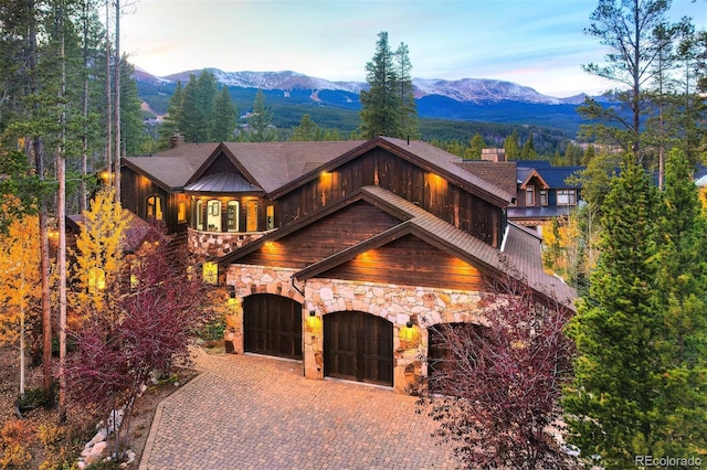 view of front of property with a mountain view and a garage