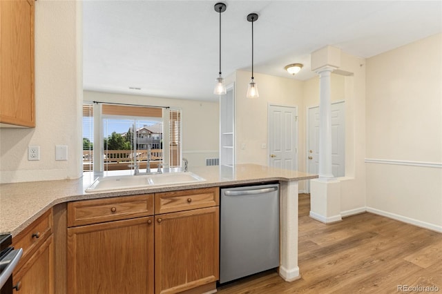 8427 S Hoyt Way Unit 203, Littleton, CO 80128 - kitchen featuring dishwasher, a peninsula, light wood-style floors, hanging light fixtures, and decorative columns