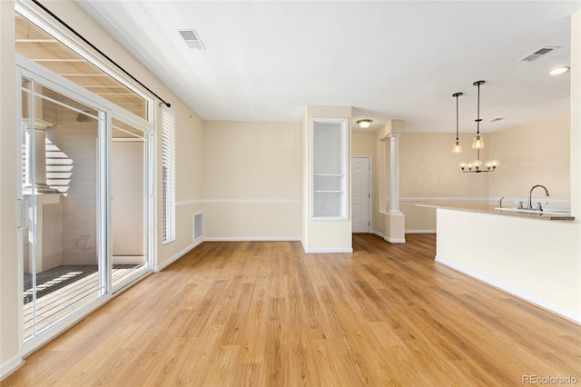 8427 S Hoyt Way Unit 203, Littleton, CO 80128 - unfurnished living room with light wood-type flooring and a chandelier