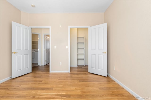 8427 S Hoyt Way Unit 203, Littleton, CO 80128 - unfurnished bedroom with washer and dryer and light wood-style flooring