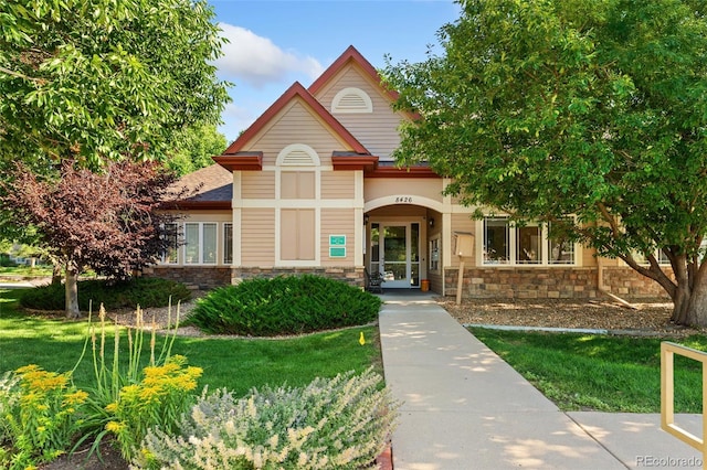 8427 S Hoyt Way Unit 203, Littleton, CO 80128 - view of front of property featuring stone siding and a front lawn