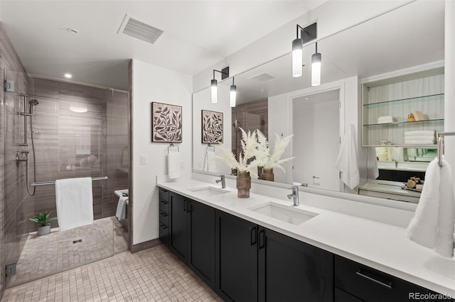 bathroom featuring vanity, walk in shower, and tile patterned floors