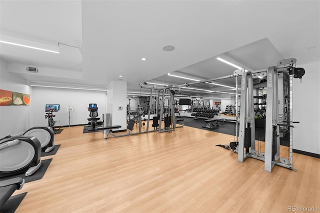 workout area with hardwood / wood-style flooring