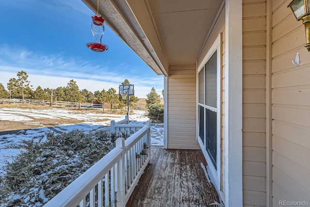 view of snow covered back of property