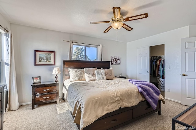 bedroom featuring ceiling fan, baseboards, a closet, and light colored carpet