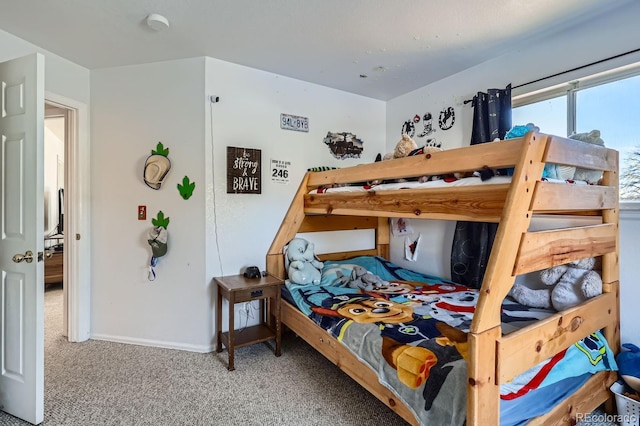 bedroom featuring baseboards and carpet flooring
