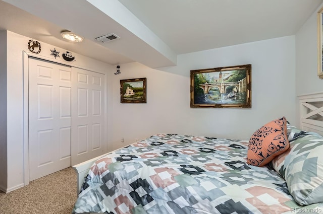 carpeted bedroom with visible vents and a closet