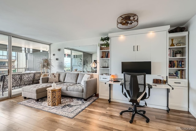 790 N Washington St Unit 1003, Denver, CO 80203 - living area featuring a desk, light wood-style flooring, and healthy amount of natural light