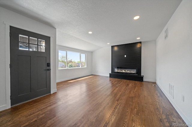 716 S Osage, Denver, CO 80223 - unfurnished living room with wood finished floors, a textured ceiling, recessed lighting, baseboards, and a fireplace