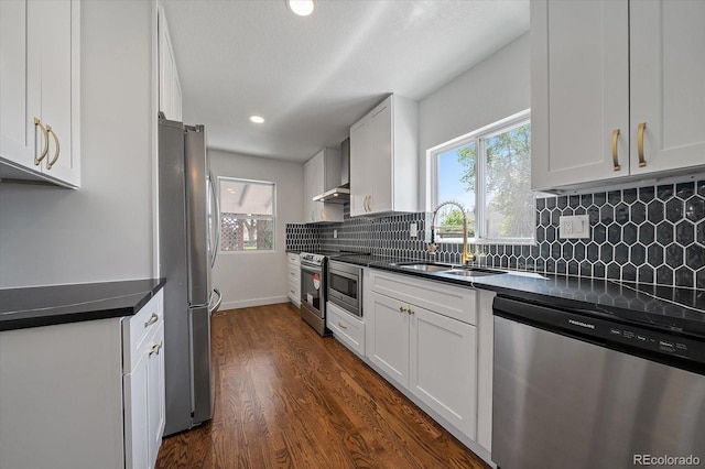 716 S Osage, Denver, CO 80223 - kitchen featuring appliances with stainless steel finishes, a sink, dark countertops, and recessed lighting
