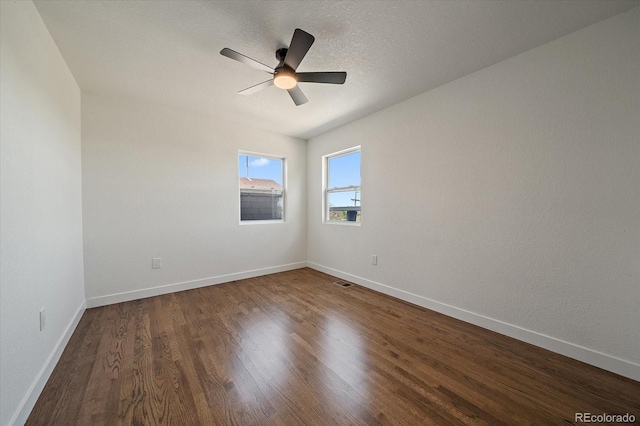 716 S Osage, Denver, CO 80223 - spare room featuring dark wood-type flooring, a ceiling fan, and baseboards
