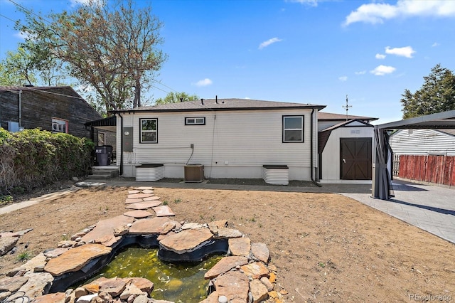716 S Osage, Denver, CO 80223 - rear view of house with a garden pond and cooling unit
